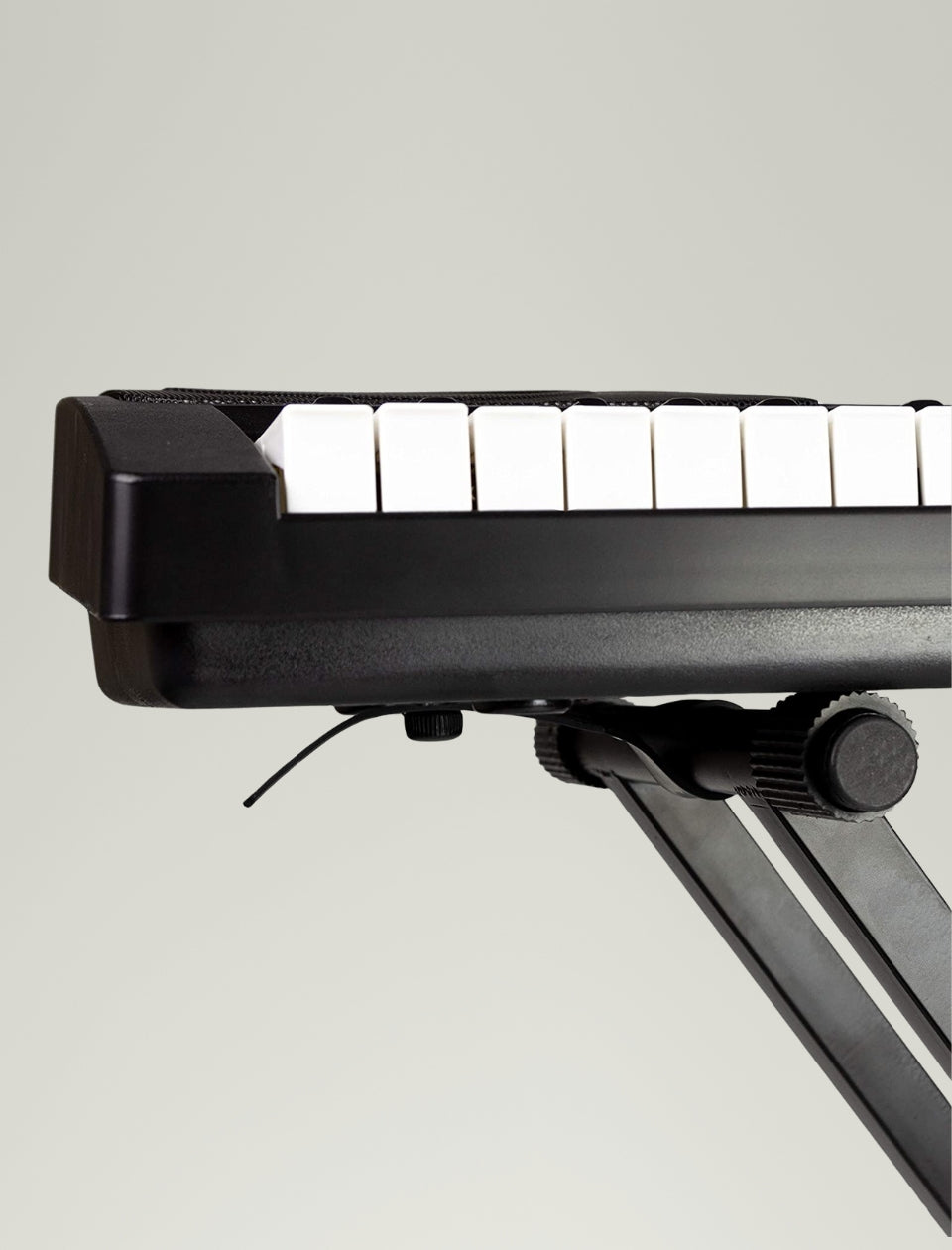 Close-up of a keyboard on a stand against a plain background.