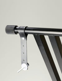Metal bracket holding a horizontal bar against a plain background