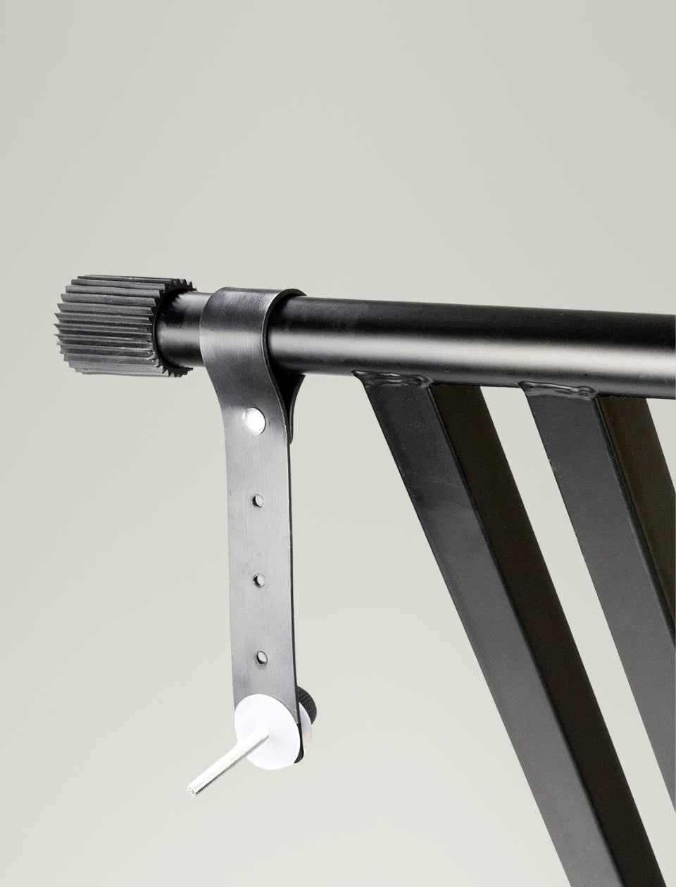Metal bracket holding a horizontal bar against a plain background